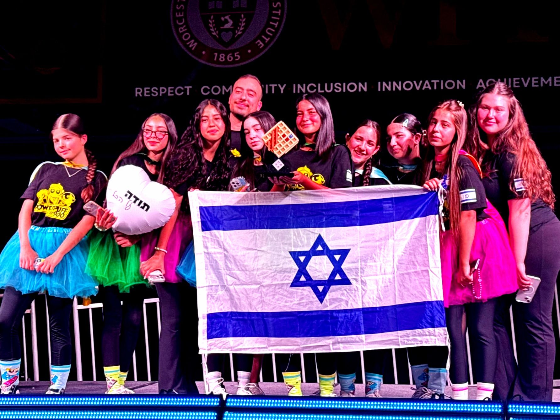 PowerPuff team with Israeli flag at Worcester robotics competition 2026