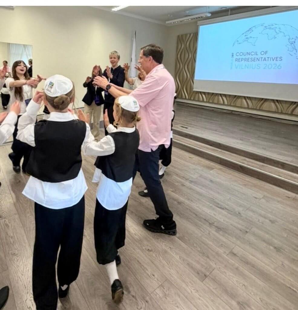 Board Chair Jon Levine and students from Vilnius Sholom Aleichem ORT Gymnasium in Lithuania participate in a traditional folk dance